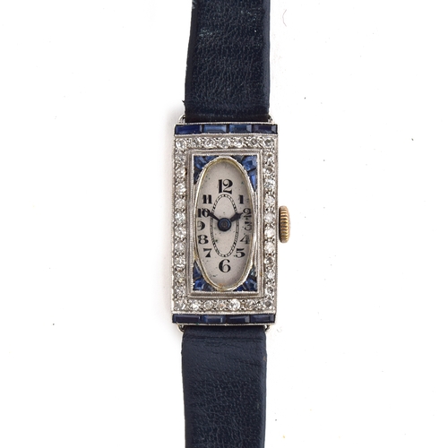 671 - A PLATINUM, DIAMOND, AND SAPPHIRE 1920S LADIES COCKTAIL WATCH (AF)
Oval white dial with graduated bl... 