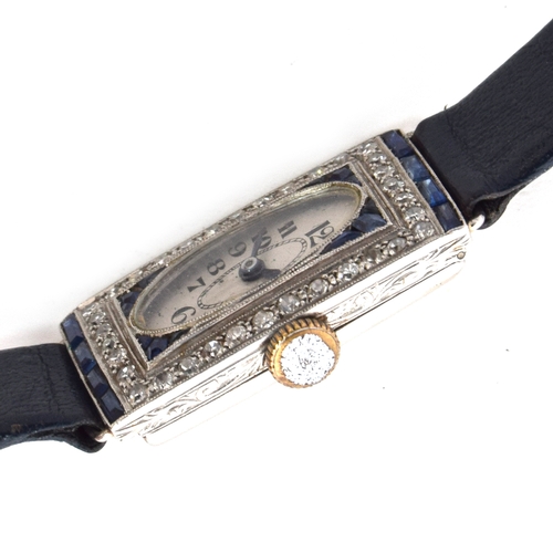 671 - A PLATINUM, DIAMOND, AND SAPPHIRE 1920S LADIES COCKTAIL WATCH (AF)
Oval white dial with graduated bl... 