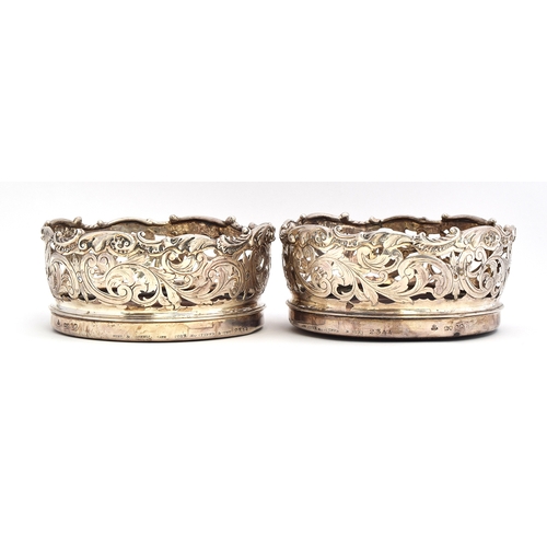 98 - A pair of large silver wine coasters by John Samuel Hunt, London 1845, the sides pierced and chased ... 