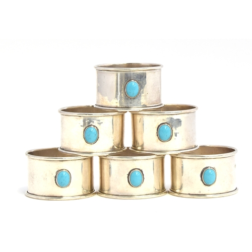 121 - A set of six silver napkin rings by Gorham Manufacturing Co, Birmingham 1921, each set with turquois... 