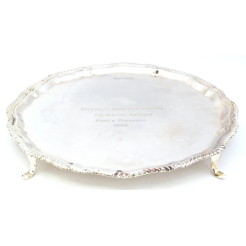 99 - A silver platter with gadrooned edge, Sheffield 1960, raised on four hoof feet, 16.4oz