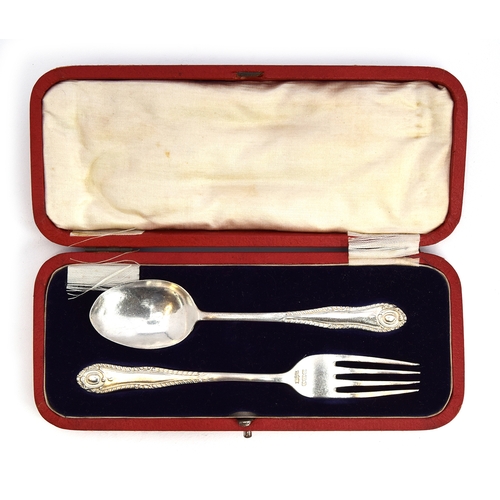 123 - A silver christening set, fork and spoon, by James Dixon & Sons Ltd, Sheffield 1915, in red leather ... 