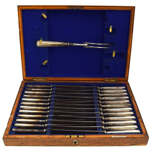 125 - A fitted canteen of 24 steel and silver handles knives and a carving fork by Isaac Ellis & Sons, She... 