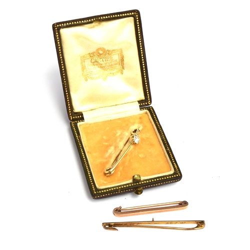 40 - A 0.5 carat solitaire diamond set bar brooch in a Cartier box; together two other 9ct bar brooches (... 