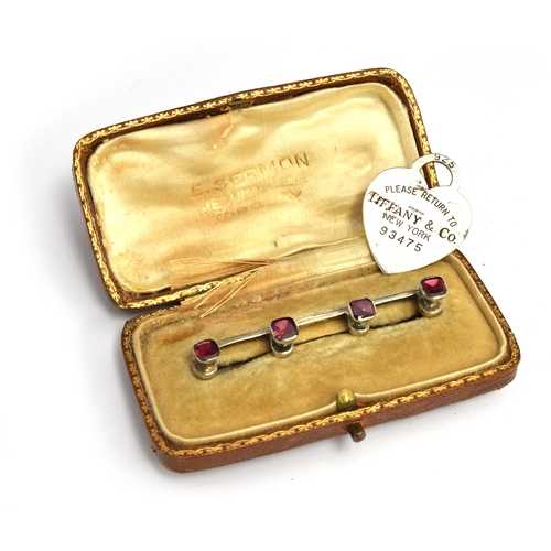 44 - A bar brooch set with four rubies; together with a Tiffany heart charm marked 'Please Return To Tiff... 