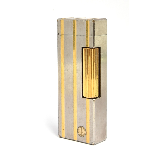 86 - A steel and gold plated Dunhill Rollagas lighter with indented gold stripes