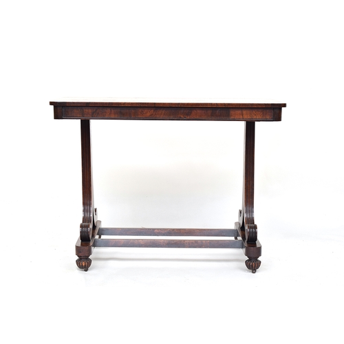 485 - An early Victorian rosewood writing desk, bookmatched top on two reeded scrolling oedestals, joined ... 