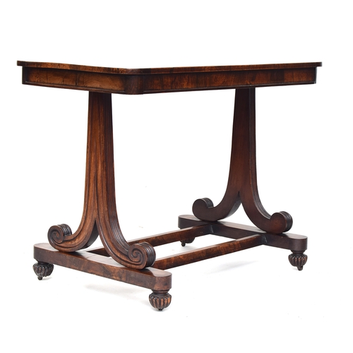 485 - An early Victorian rosewood writing desk, bookmatched top on two reeded scrolling oedestals, joined ... 