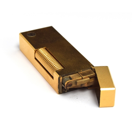 89 - A gold plated Dunhill Rollagas lighter with engine turned decoration, 6.4cm high, in fitted Dunhill ... 