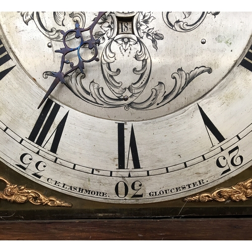 733 - A longcase clock by C E Lashmore, Gloucester, the domed oak case with broken pediment, profusely car... 