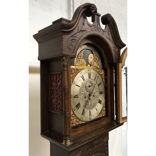 733 - A longcase clock by C E Lashmore, Gloucester, the domed oak case with broken pediment, profusely car... 