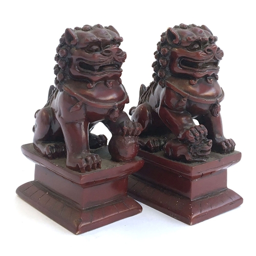 55 - A pair of resin food dogs on plinths, each 11cmH,