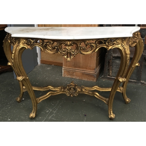 720 - A Louis XVI style carved giltwood console table, the marble top above pierced scrolling foliate frie... 