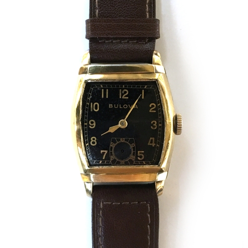 581 - A BULOVA GENTLEMAN'S GOLD FILLED WATCH
Circa 1940s, black dial with Arabic numbers, steel back
Movem... 