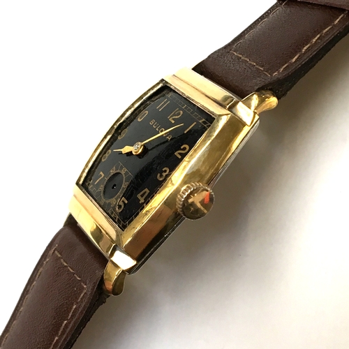 581 - A BULOVA GENTLEMAN'S GOLD FILLED WATCH
Circa 1940s, black dial with Arabic numbers, steel back
Movem... 