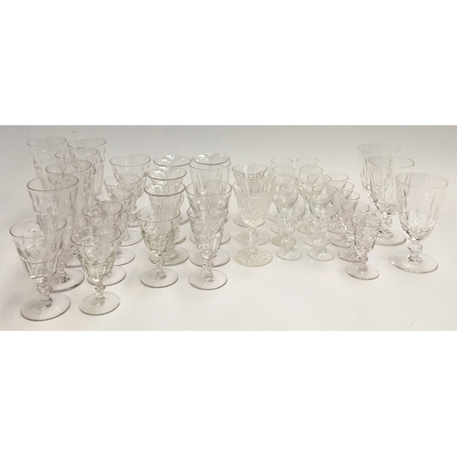 69 - A collection of cut glassware to include port, sherry, wine glasses and champagne flutes