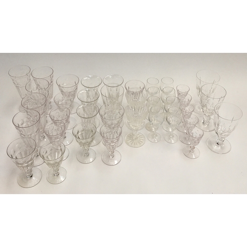 69 - A collection of cut glassware to include port, sherry, wine glasses and champagne flutes