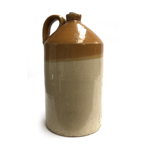 92 - A stoneware flagon with loop handle, marked 'Mitchell Toms & Co. ltd, distillery, Chard', 41cmH