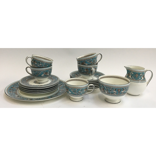 102 - A Wedgwood 'Florentine' part tea service to unclude teacups (5), saucers (6), small plates (6), cake... 