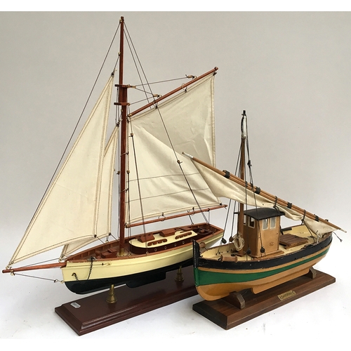 1080 - A wooden model of a yacht with rigging, LOA 51cm together with a wooden model of a fishing trawler w... 