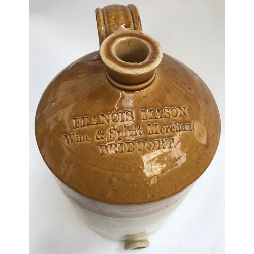 121 - A stoneware flagon with loop handle, marked 'Francis Mason, Wine & Spirit Merchant, Bridport', 49cmH