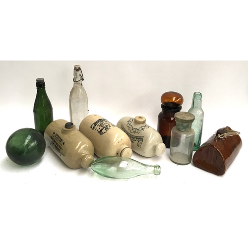 128 - A mixed lot to include four stoneware hot water bottles, chemist's jars, and several vintage glass b... 