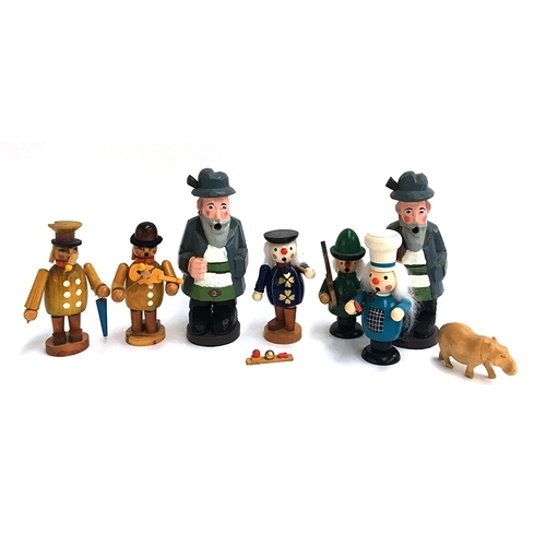 1042 - A collection of seven handmade German wooden figurines; together with a carved wooden hippo (8)