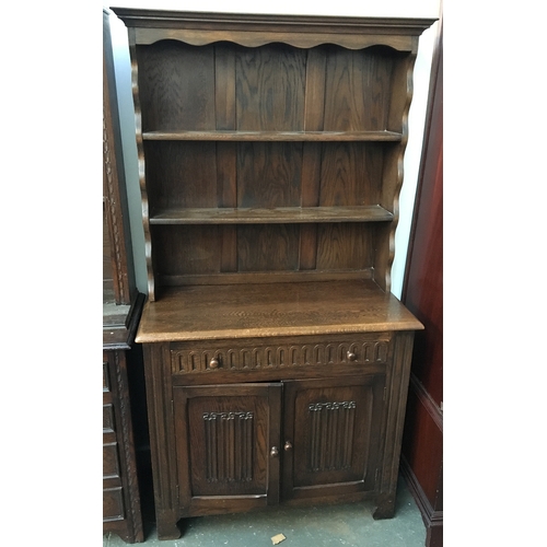 843 - A cottage style kitchen dresser, the single drawer over linenfold carved cupboard doors, 90cmW