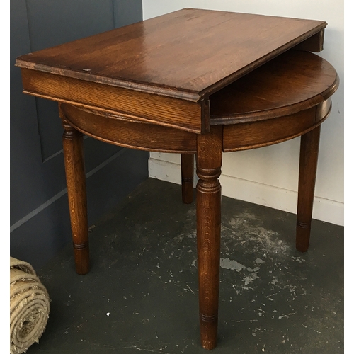 857 - A solid oak circular extending dining table, with spare leaf, 90cmD