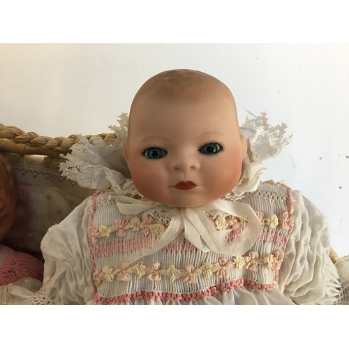 1030 - A small 20th century doll with ceramic head, marked 'Rachel Karslake 1985'; together with two other ... 