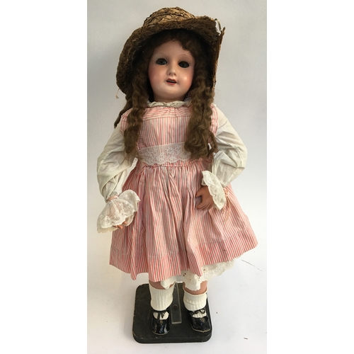 1031 - A French SFBJ 301 doll with blue sleeping eyes in pinstripe dress