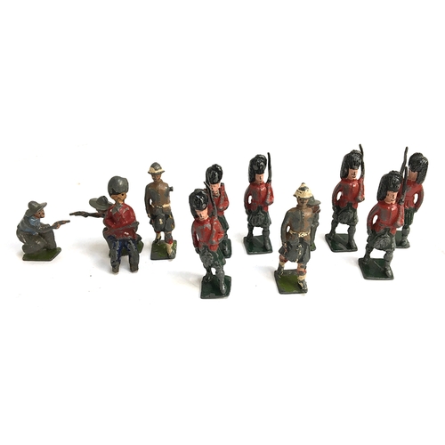 1003 - A collection of metal toy Scottish soldiers, together with two cowboys and a number of resin toy sol... 