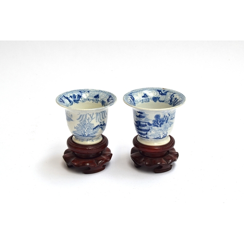 150 - A pair of 19th century Chinese blue and white tea cups, marked to base, on hardwood plinths, 5.5cm h... 