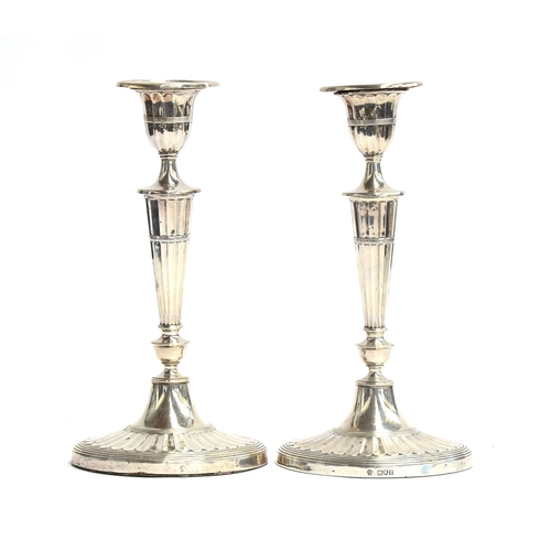 83 - A pair of silver candlesticks by William Hutton & Sons Ltd, London 1908, in the Adam style, having d... 