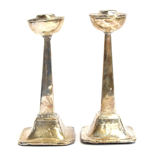 84 - A pair of unusual silver candlesticks, Birmingham 1929, hemispherical bobeches on square taped colum... 