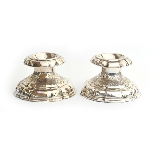 56 - A pair of probably Indian silver salts, lightly chased with Eastern motifs, each approximately 6cm h... 