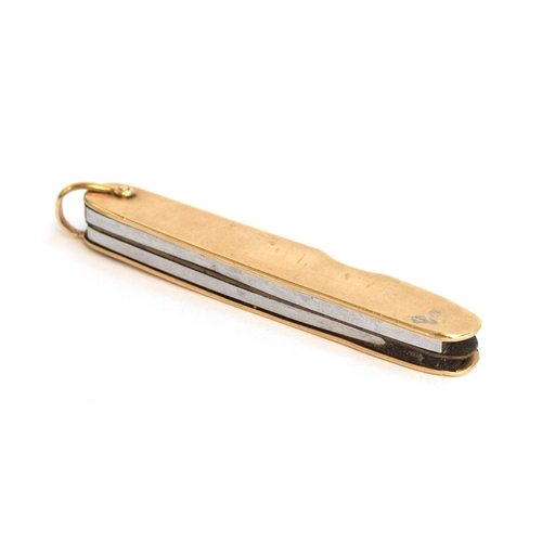 113 - A 14ct gold bound folding pocket knife, with small steel blade and pair of scissors, 6.7cm long