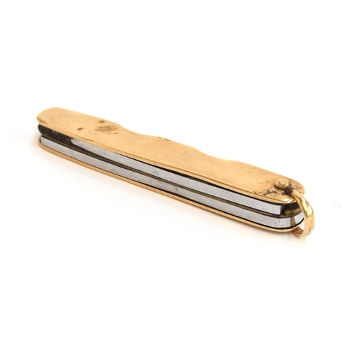 113 - A 14ct gold bound folding pocket knife, with small steel blade and pair of scissors, 6.7cm long