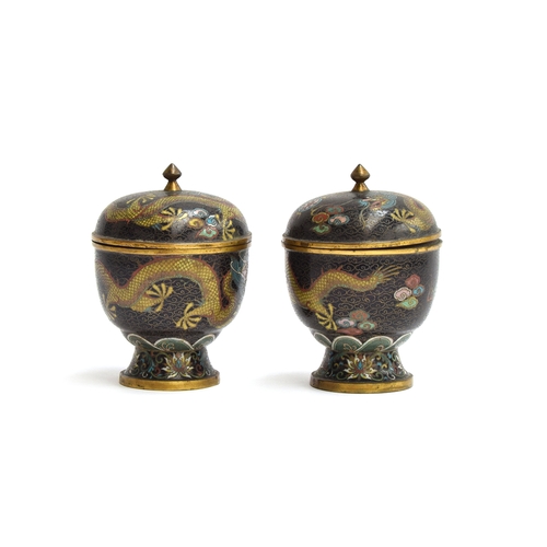 148 - A pair of early 20th century Chinese lidded cloisonné urns, depicting dragons on a black ground chas... 