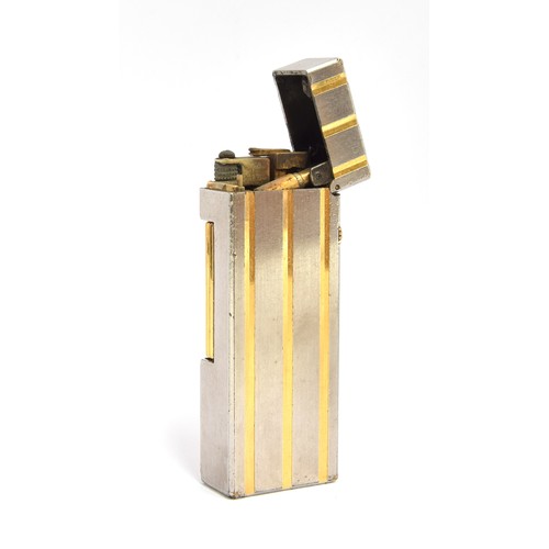 115 - A steel and gold plated Dunhill Rollagas lighter with indented gold stripes