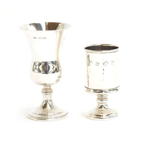 69 - Two modern silver shot glasses, the smaller 7.5cm high, Birmingham 1971 and 1984, 4oz