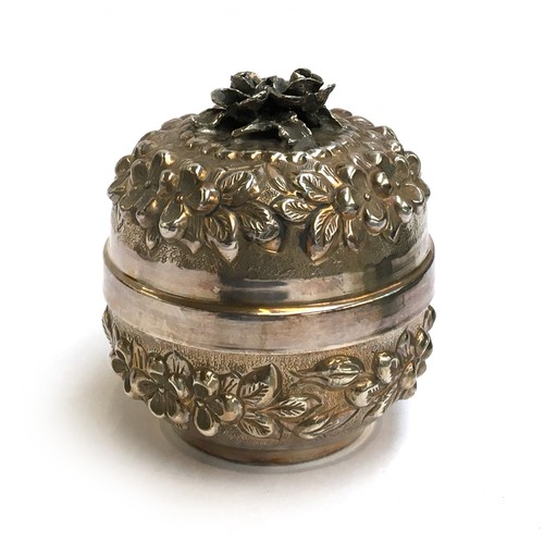 79 - A Continental 900 silver lidded pot, chased with flowers and foliage, approximately 12cm high, 9.4oz