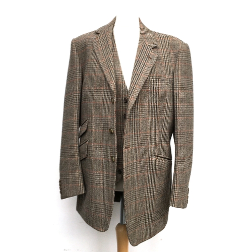 593 - A gent's three piece tweed suit, tailored by Moss Bros., 1983, the jacket with double vent to rear a... 