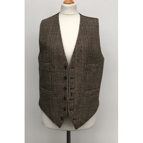 593 - A gent's three piece tweed suit, tailored by Moss Bros., 1983, the jacket with double vent to rear a... 