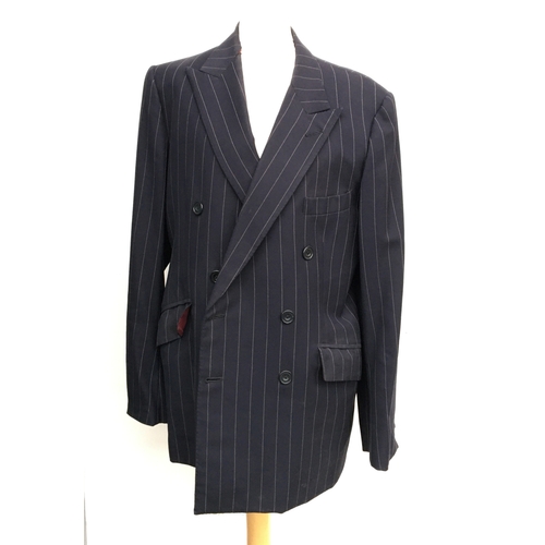 601 - A navy double breasted pinstripe suit by A.T. McGurrell, London W1 (1995), with wine coloured lining... 