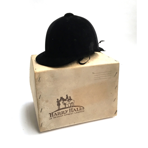 588 - A 1950s/60s black velvet riding hat (Harry Hall Ltd., London W1), in original box, approx. size 7