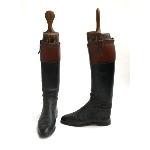 575 - A pair of gent's black leather hunting boots with mahogany tops, and wooden trees