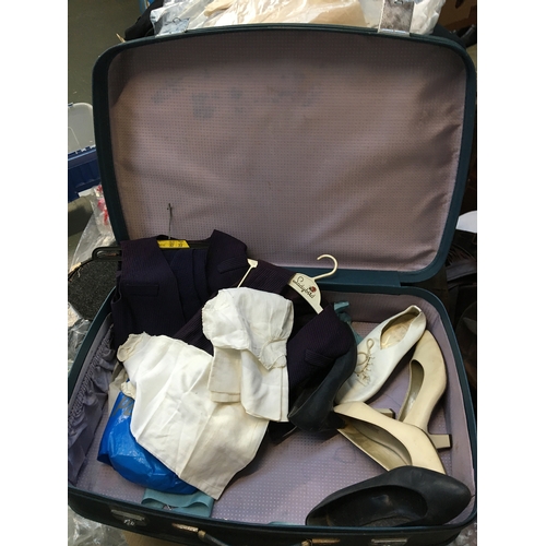 543 - A vintage blue Revelation suitcase containing various children's clothes and shoes; together with a ... 