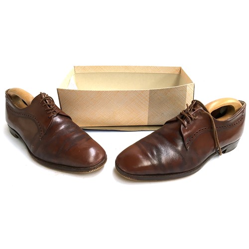 640 - A pair of gents Church's brown lace up shoes, size 13; together with wooden trees