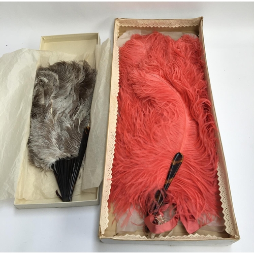 513 - Two large vintage ostrich feather fans in their original boxes, the larger approx 70cmL